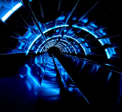 a dark tunnel with futuristic blue lights